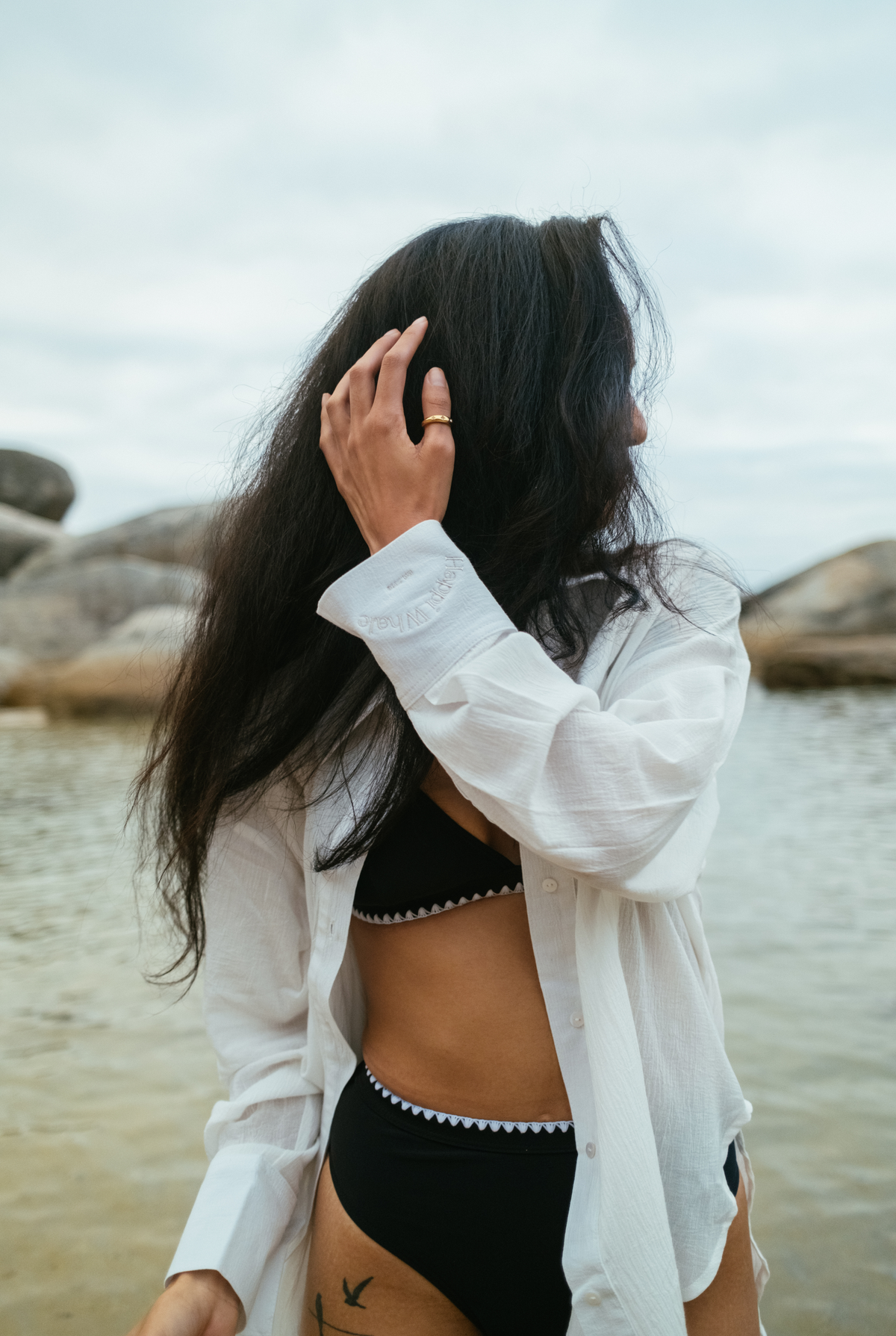 Hillie's Breeze Shirt worn open over a black bikini as a beach cover-up